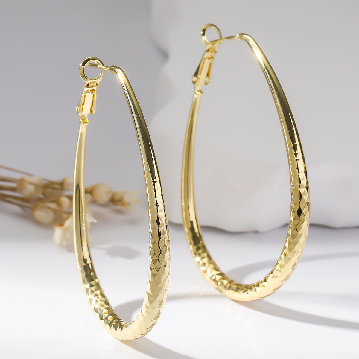 Radiant Teardrop Hoop Earrings in Polished Gold