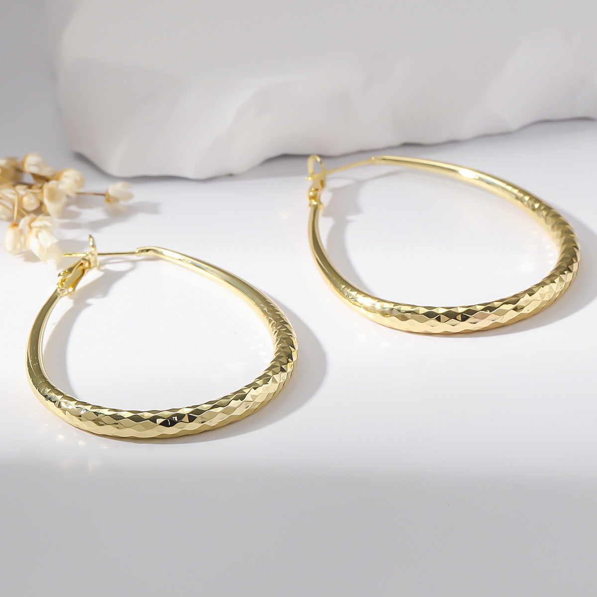 Radiant Teardrop Hoop Earrings in Polished Gold